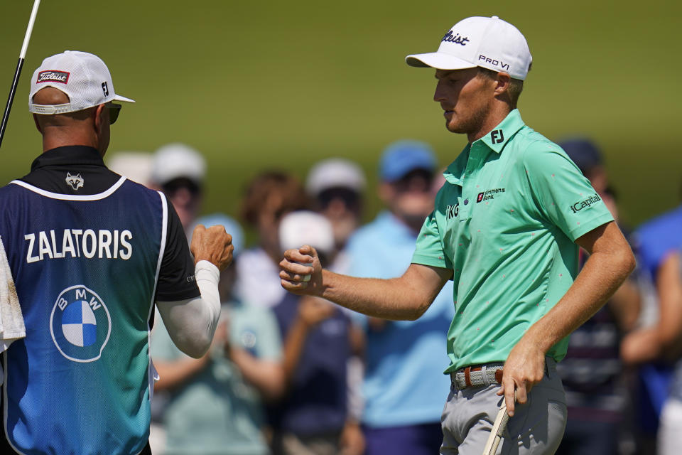 Will Zalatoris, right, fist bumps his caddie after a birdie on the first hole during the second round of the BMW Championship golf tournament at Wilmington Country Club, Friday, Aug. 19, 2022, in Wilmington, Del. (AP Photo/Julio Cortez)