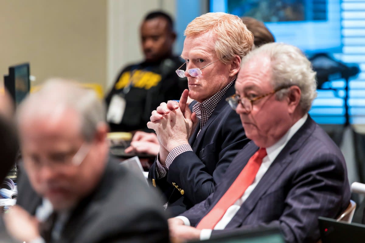 Alex Murdaugh, centre,  listens to witness testimony during his double murder trial at the Colleton County Courthouse (AP)