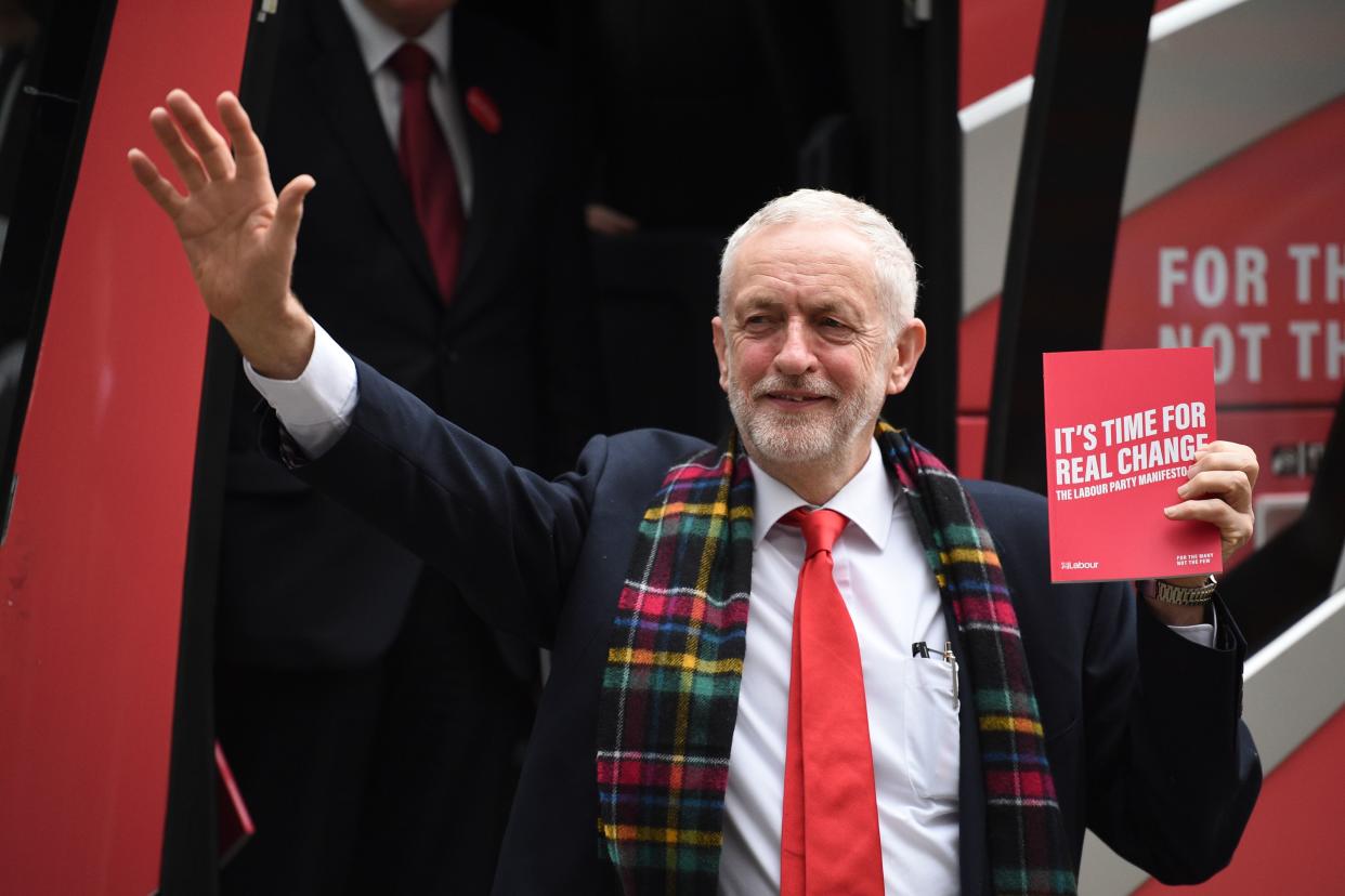 Britain's Labour Party leader Jeremy Corbyn holds up a copy of their general election manifesto as he arrives for a manifesto launch event in Birmingham, northwest England on November 21, 2019. - Britain will go to the polls on December 12, 2019 to vote in a pre-Christmas general election. (Photo by Oli SCARFF / AFP) (Photo by OLI SCARFF/AFP via Getty Images)
