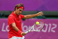 LONDON, ENGLAND - JULY 28: Roger Federer of Switzerland returns a shot against Alejandro Falla of Colombia during their Men's Singles Tennis match on Day 1 of the London 2012 Olympic Games at the All England Lawn Tennis and Croquet Club in Wimbledon on July 28, 2012 in London, England. (Photo by Clive Brunskill/Getty Images)