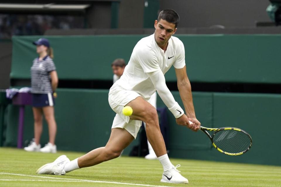 Spain’s Carlos Alcaraz returns the ball to Germany’s Jan-Lennard Struff during their men’s singles match on day one of Wimbledon.