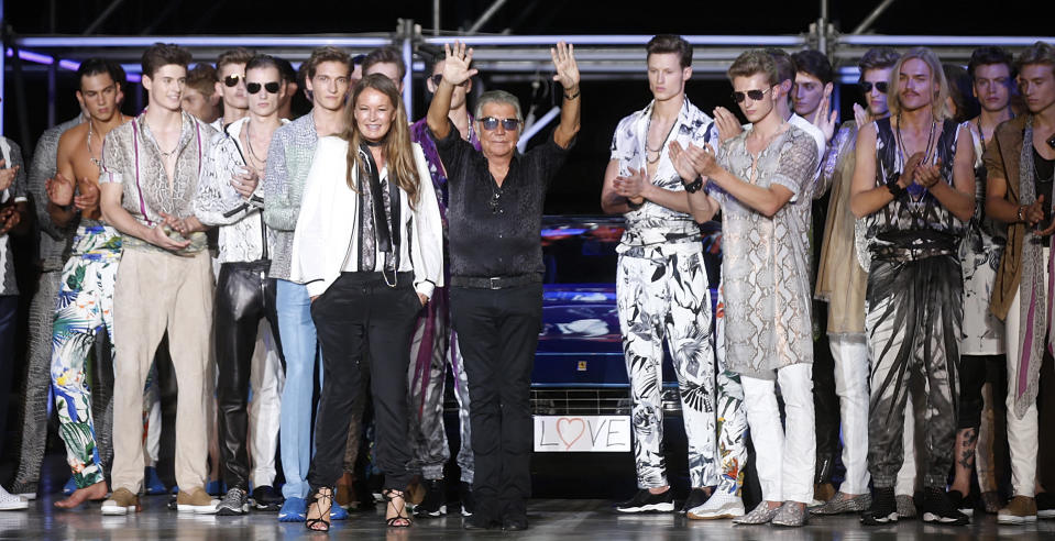 FILE - Italian fashion designer Roberto Cavalli, center, acknowledges the applause of the audience after presenting the Roberto Cavalli men's Spring-Summer 2015 collection, part of the Milan Fashion Week, in Milan, Italy, June 24, 2014. Italy’s world-famous fashion designer Roberto Cavalli – known for his flamboyant and glamorous style -- died on Friday, April 12, 2024 aged 83, his company announced in an Instagram post. (AP Photo/Luca Bruno, File)