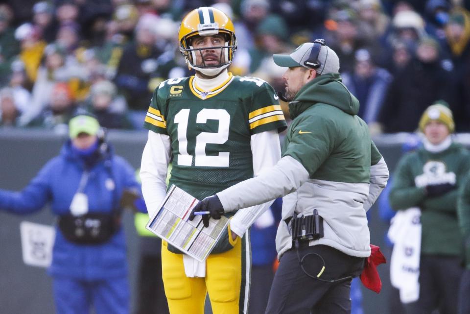 Green Bay Packers head coach Matt LaFleur talks to Aaron Rodgers during the first half of an NFL football game against the Chicago Bears Sunday, Dec. 15, 2019, in Green Bay, Wis. (AP Photo/Mike Roemer)