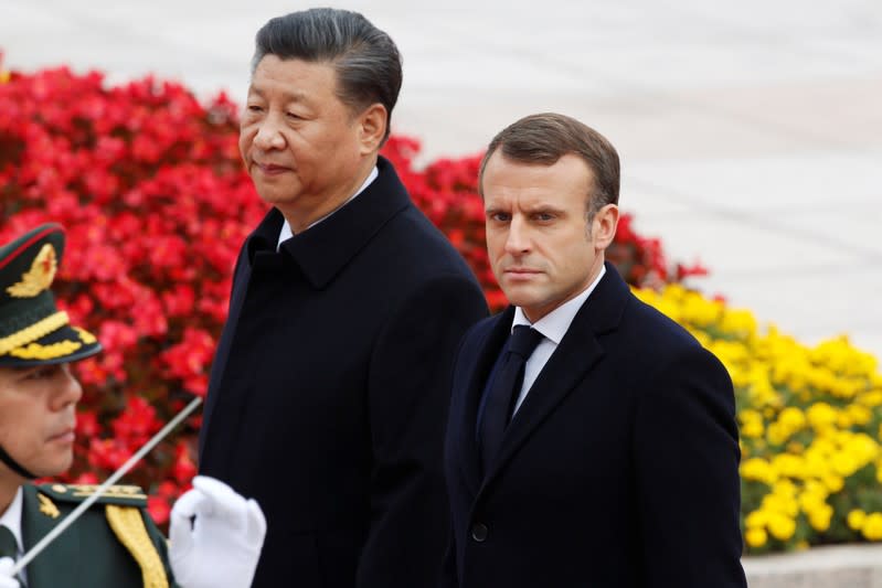 French President Emmanuel Macron attends a welcome ceremony with Chinese President Xi Jinping outside the Great Hall of the People in Beijing