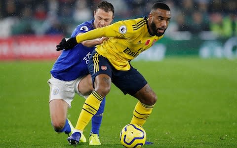 Arsenal's Alexandre Lacazette in action with Leicester City's Jonny Evans - Credit: REUTERS/Andrew Yates&nbsp;