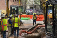 Workers try to fix a leaking water main junction on Monday, June 3, 2024, in Atlanta. Water pressure is returning to downtown Atlanta and nearby neighborhoods, after a water outage that began Friday. (AP Photo/Jeff Amy)