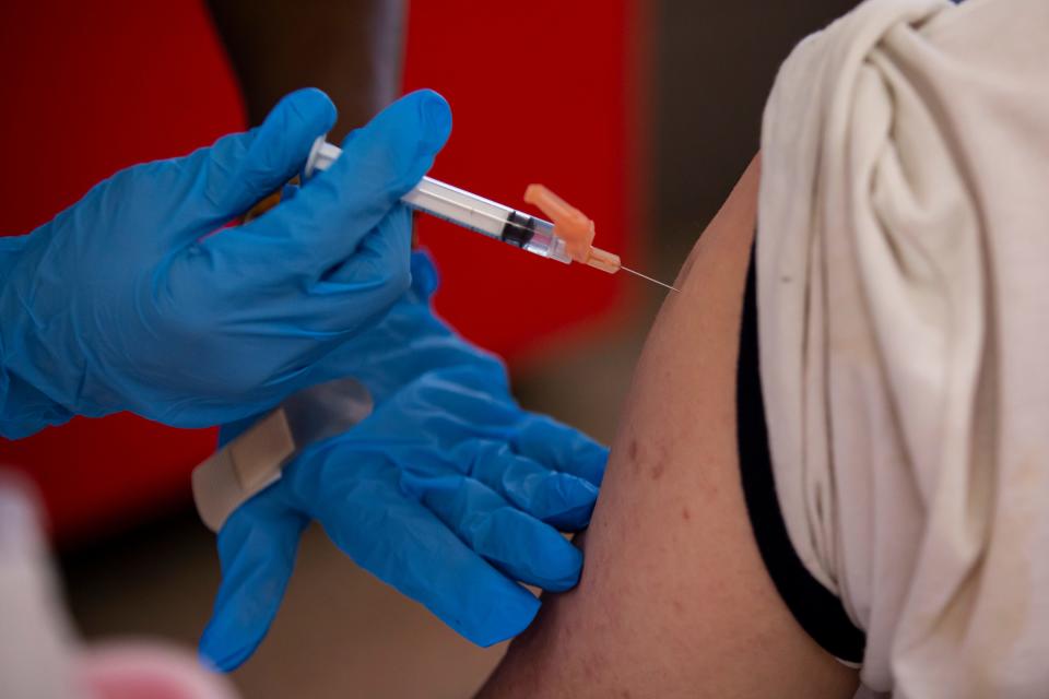 Many employers are pausing their vaccine requirements pending the outcome of the legal challenge to the federal rule that employees of companies with at least 100 workers be vaccinated.