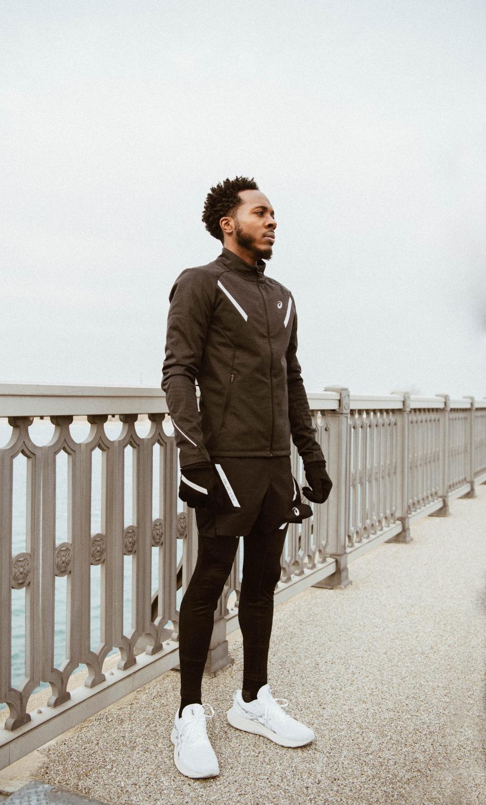 Detroit native Lance Woods, co-founder of WeRun313, stands on the Belle Isle bridge during the production of the "Live Uplifted" documentary made by the ASICS shoe company.