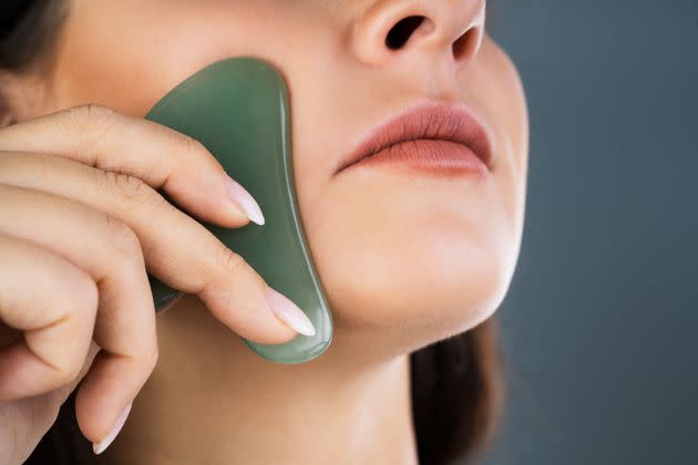 A gua sha tool is meant to be gently pressed all over your neck, face and décolletage. (Photo: AndreyPopov via Getty Images)