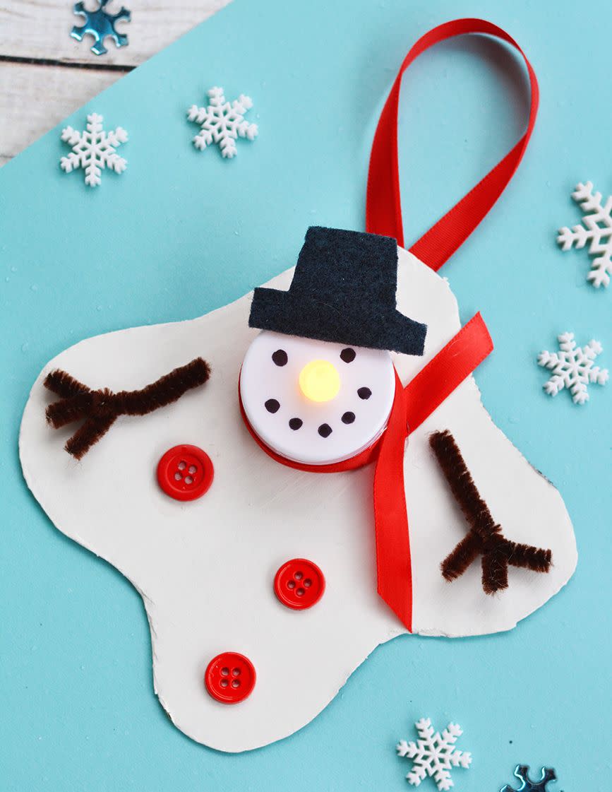<p>This craft is intended to be an ornament, but it also works as a 3D card (that you can hang up on the tree afterward). The tea light adds to the overall effect.</p><p><a href="https://www.iheartartsncrafts.com/melted-snowman-tea-light-ornament/" rel="nofollow noopener" target="_blank" data-ylk="slk:Get the tutorial at I Heart Arts and Crafts »;elm:context_link;itc:0;sec:content-canvas" class="link "><em>Get the tutorial at I Heart Arts and Crafts »</em></a></p>