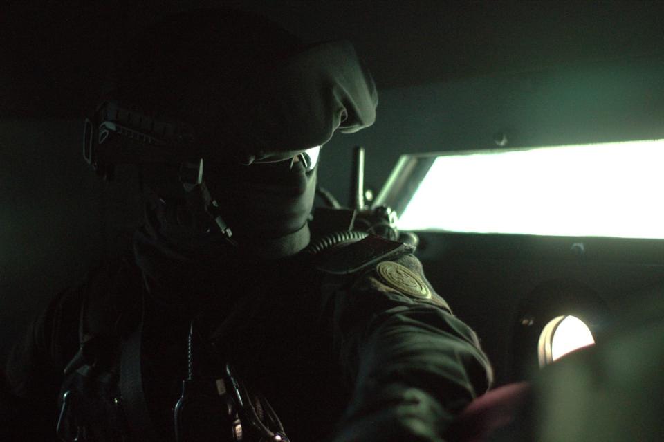 A Chihuahua state police SWAT officer looks out from inside an armored vehicle during a recent operation to arrest drug dealers in Juárez, Mexico.