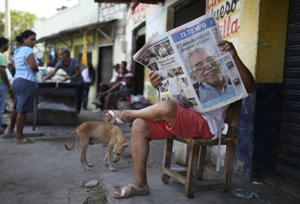 In this April 18, 2014, photo, a man reads a newspaper fronted with the news of the death of Nobel laureate Gabriel Garcia Marquez, in Aracataca, the town were he was born in Colombia's Caribbean coast. Garcia Marquez died in Mexico City on Thursday April 17. (AP Photo/Ricardo Mazalan)