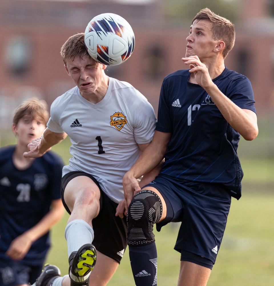 Garfield junior Ethan Bittence connects with the ball while Rootstown sophomore Gianni Damicone defends during a recent match at Rootstown High School.