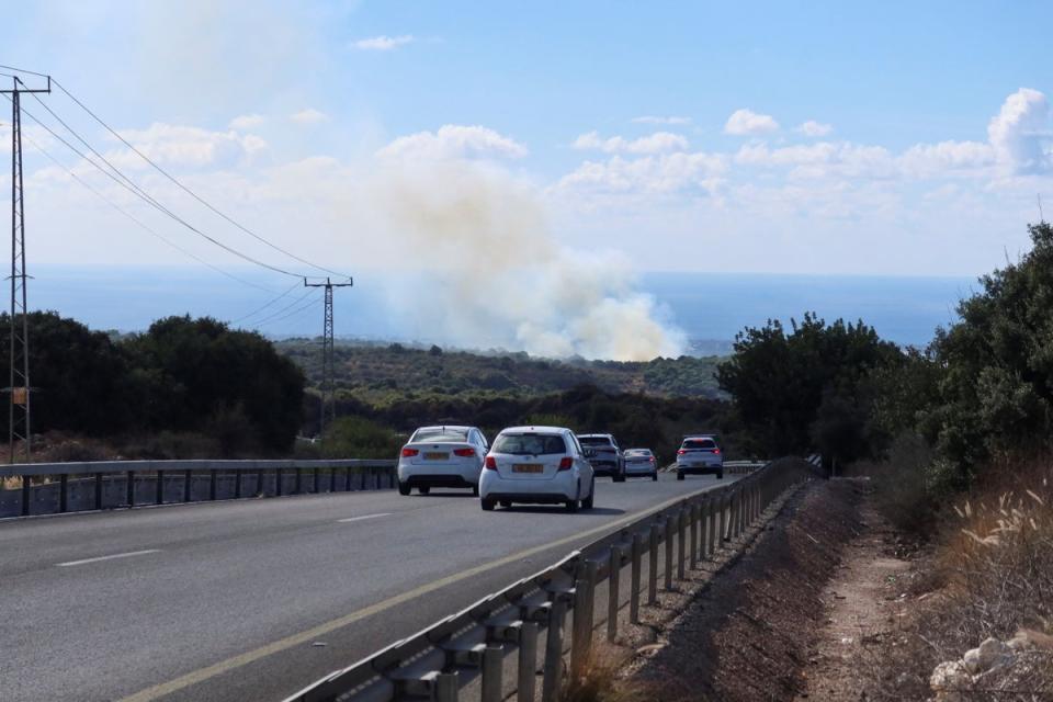 Motorists stop as smoke rises above western Galilee (REUTERS)