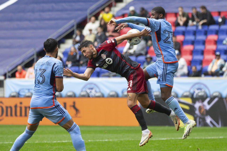 New York City FC Tayvon Gray, right, duels for the ball against Toronto FC Jonathan Osorio, center, during an MLS soccer match at Red Bull Arena, Sunday, Sept. 24, 2023, in Harrison, N.J. (AP Photo/Andres Kudacki)