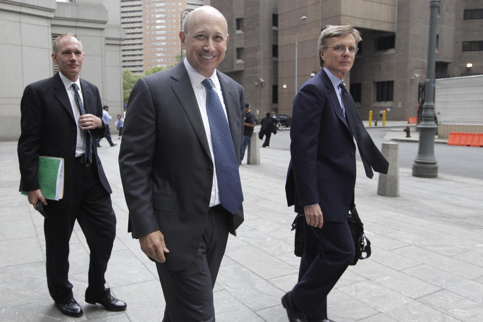 Goldman Sachs chairman and chief executive officer Lloyd Blankfein, center, leaves Federal court, Thursday, June 7, 2012 in New York. Blankfein testified at the New York insider trading trial of a former Goldman board member Rajat Gupta. (AP Photo/Mary Altaffer)