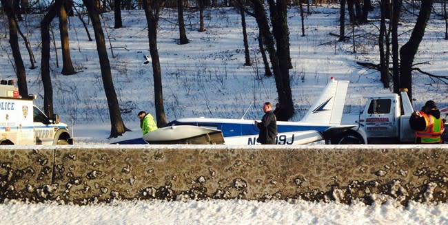 In this photo provided by Patricia Sapol, emergency personnel respond to a light airplane that made an emergency landing on the Major Deegan Expressway in the Bronx borough of New York, Saturday, Jan. 4, 2014. The Piper PA-28, set down at around 3:20 p.m. on the northbound side of the highway. Police and fire officials said neither the male pilot nor two female passengers appeared to have been badly hurt. (AP Photo/Patricia Sapol)