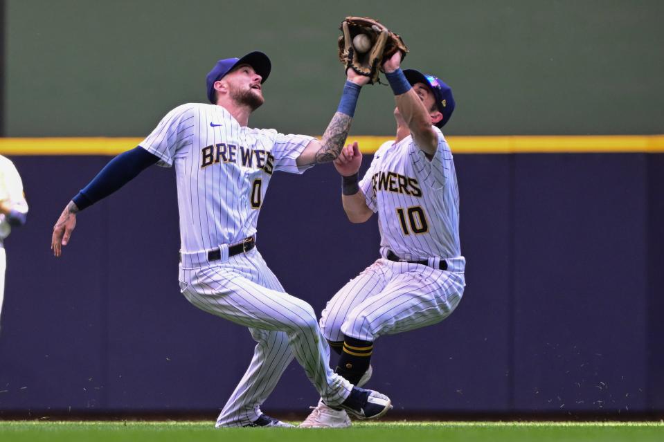 Brewers second baseman Brice Turang (0) collides with rightfielder Sal Frelick after catching a popup by Braves leftfielder Kevin Pillar in the seventh inning Sunday at American Family Field.