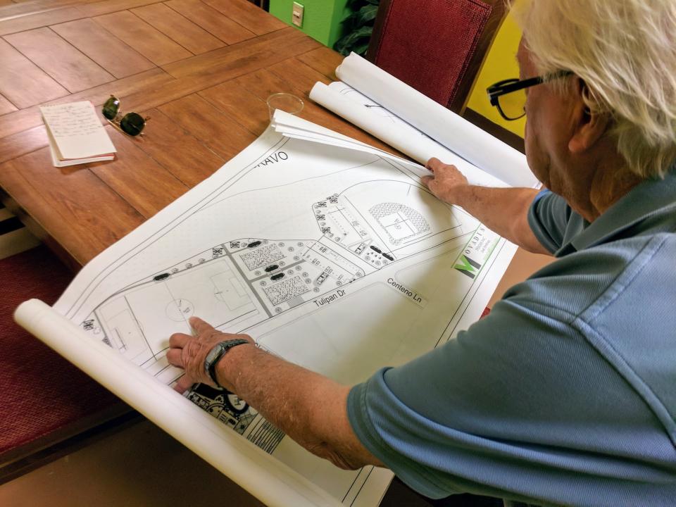 Rio Bravo Mayor Francisco Pe&ntilde;a displays architectural plans for a park the city will inaugurate on July 4, 2018. The park will sit directly across from the culvert where a migrant woman named Claudia G&oacute;mez allegedly crossed into the United States before a Border Patrol agent shot and killed her. (Photo: Roque Planas)