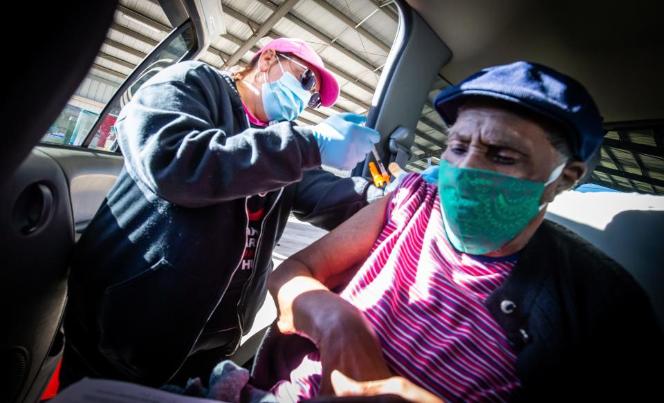 Registered Nurse JoAnn Abrahim gives 93-year-old Pearl Matthews the Pfizer vaccine in March.