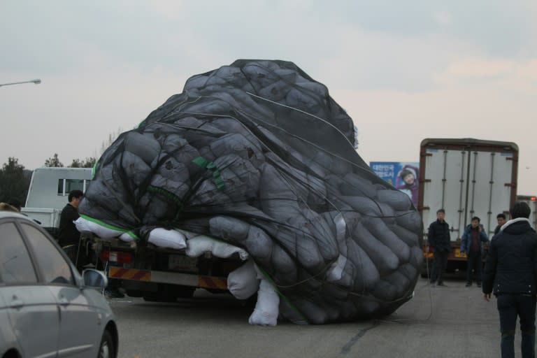 Cargo on an overloaded vehicle slumps off to the side after arriving from the Kaesong joint industrial zone, outside a military checkpoint in Paju on February 11, 2016