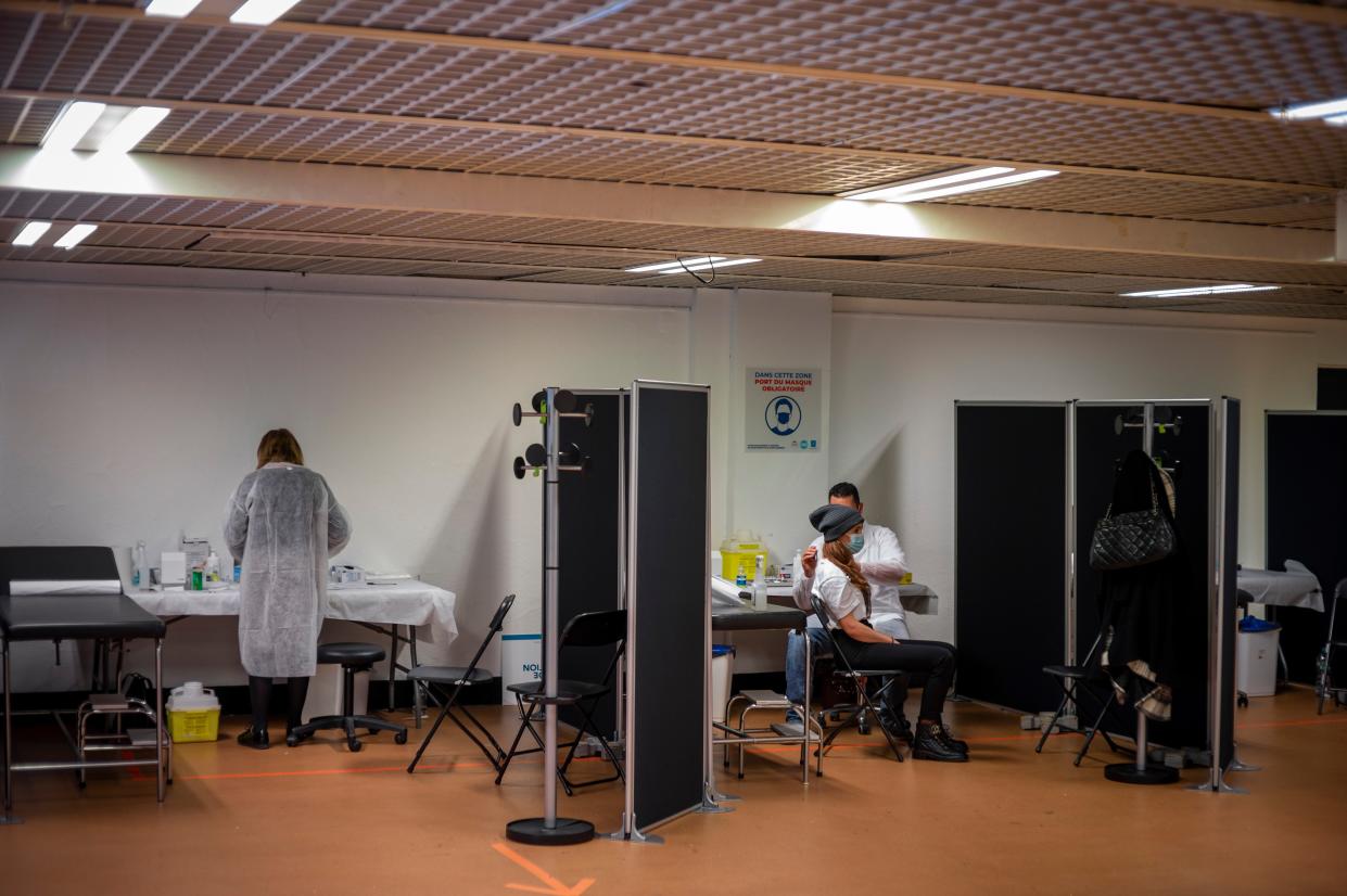 People get vaccinated against COVID-19 at the Cannes Palace of Festivals and Conferences on Jan. 13, 2021, in Cannes, France. The Cannes Palace of Festivals and Conferences, the flagship for the Cannes Film Festival, has been converted into a vaccination center.