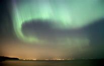 The northern lights fill the sky over the south shore of Lake Superior east of Superior, Wis. above Duluth, Minn., early Sunday, July 15, 2012. A solar storm sparked the spectacular northern lights display in the skies over the Upper Midwest. (AP Photo/The Duluth News-Tribune, Andrew Krueger)