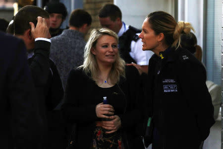 A woman reacts outside Parsons Green tube station in London, Britain September 15, 2017. REUTERS/Kevin Coombs