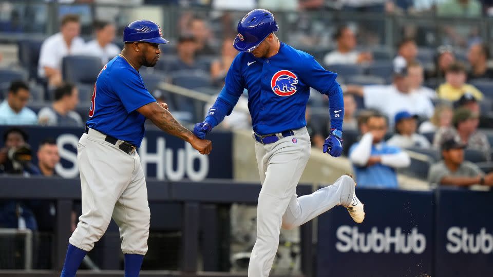 Chicago Cubs' Cody Bellinger, right, celebrates with third base coach Willie Harris as he runs the bases after hitting a home run. - Frank Franklin II/AP