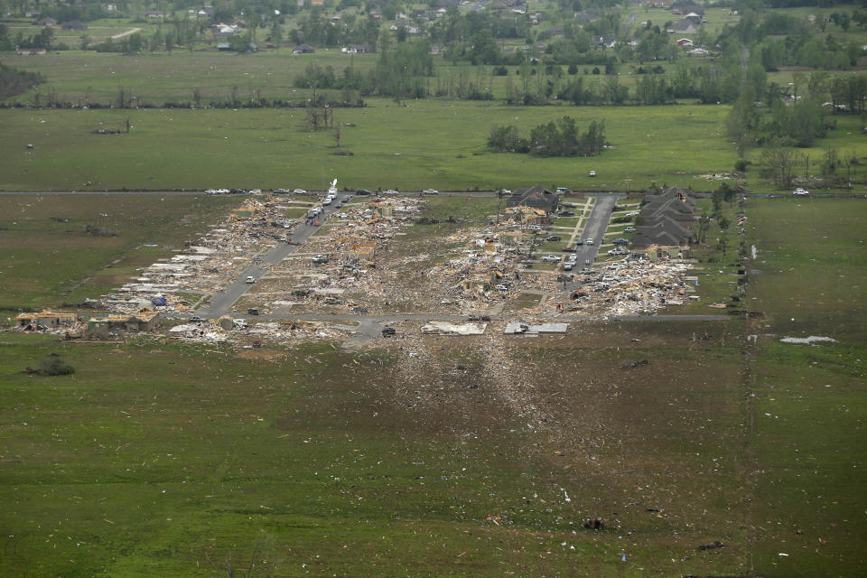 A debris trail from a tornado leads away from a Vilonia, Ark., neighborhood Monday, April 28, 2014, after a deadly tornado struck the town late Sunday. A dangerous storm system that spawned a chain of deadly tornadoes killed dozens from the Midwest to the Deep South. (AP Photo/Danny Johnston)