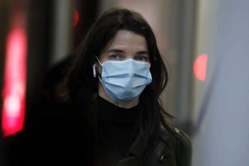 A pedestrian wears a protective face mask on 23rd Street in New York City on December 2, 2021. Some hospitals, universities and businesses across the United States are mandating masking again in response to rising cases of COVID-19. File Photo by Peter Foley/UPI