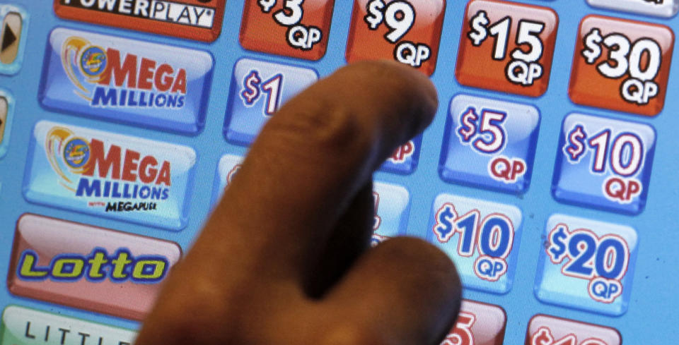 A lottery vendor punches in a $5 quick pick sale for the Mega Millions drawing in Chicago, Thursday, March 29, 2012. With the Mega Millions jackpot over $500 million, Illinois picked the right week to become the first state in the nation to sell lottery tickets online, and other states are watching closely to see how it plays out. They're also wondering if the payoff will prompt Illinois to take the next big step: launching online poker, blackjack and other casino games.(AP Photo/Charles Rex Arbogast)