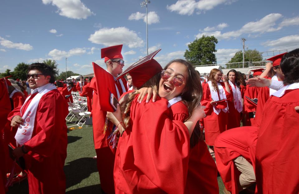 Graduate Grace deBenedictis, right, hugs classmate Caroline Ghelli at the conclusion of Milton High School graduation ceremony Sunday, June 5, 2022.