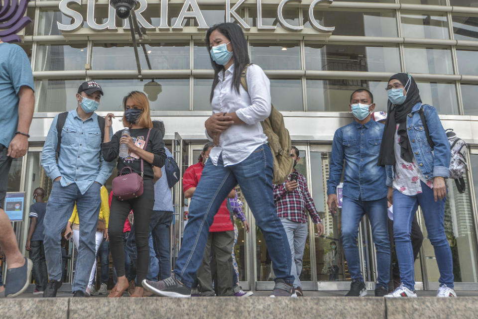 Pedestrians wearing face masks at a public area in Kuala Lumpur August 1, 2020. — Picture by Shafwan Zaidon