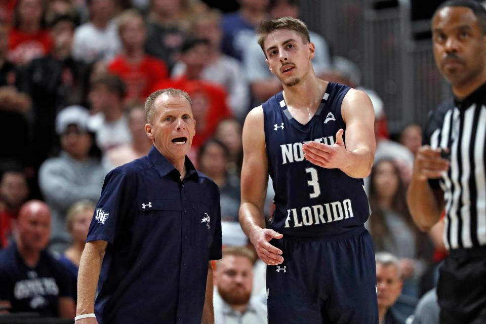 University of North Florida basketball coach Matthew Driscoll (L) admits with the transfer portal and NIL money being offered players, it's going to be near impossible for him and other mid-major programs to keep quality players like Carter Hendricksen (3) from leaving for greener pastures.