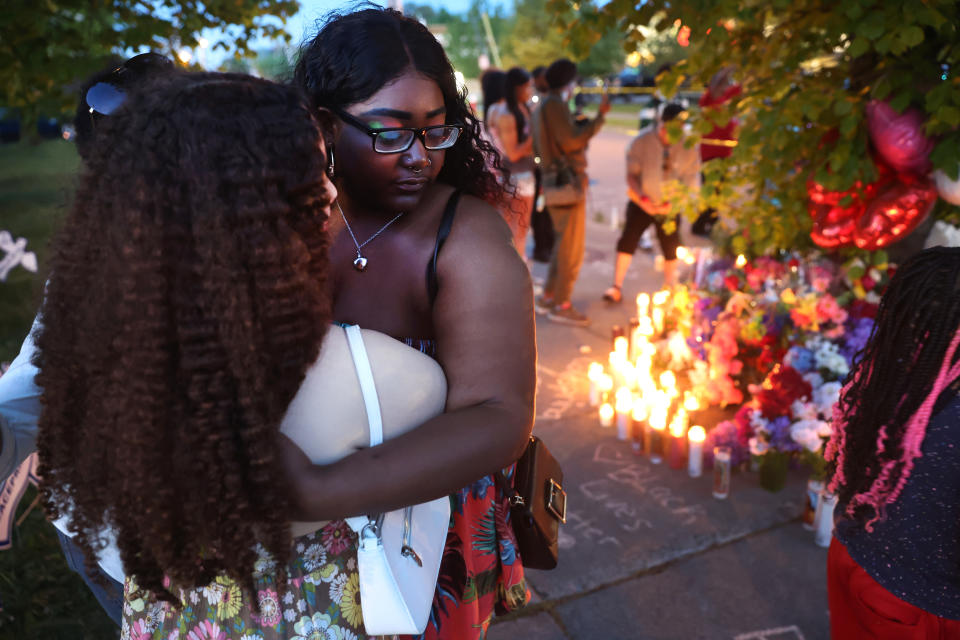 Mourners support each other while visiting a makeshift memorial outside of Tops market on May 15, 2022 in Buffalo, N.Y. A gunman opened fire at the store yesterday killing 10 people and wounding another three. The attack was believed to be motivated by racial hatred. - Credit: Scott Olson/Getty Images