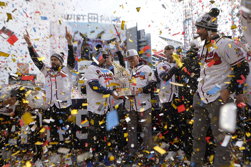 Atlanta Braves manager Brian Snitker holds the Commissioner's Trophy during a celebration at Truist Park, Friday, Nov. 5, 2021, in Atlanta. The Braves beat the Houston Astros 7-0 in Game 6 on Tuesday to win their first World Series MLB baseball title in 26 years. (AP Photo/John Bazemore)