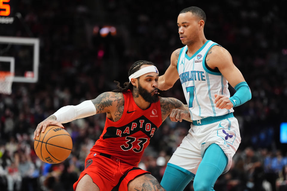 Toronto Raptors guard Gary Trent Jr. (33) drives into Charlotte Hornets guard Bryce McGowens (7) during second-half NBA basketball game action in Toronto, Sunday, March 3, 2024. (Frank Gunn/The Canadian Press via AP)