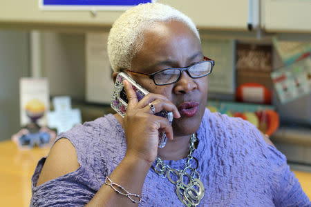 Community organizer Trina Turner, a pastor who deals with economically disadvantaged people, talks on her cellphone in her office in Stockton, California U.S., April 24, 2018. Picture taken April 24, 2018. REUTERS/Jane Ross