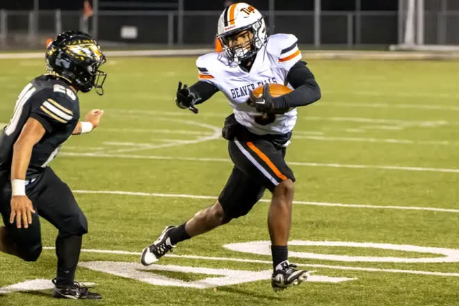 Beaver Falls running back Da'Talian Beauford stiff-arms a defender in the Tigers' first-round playoff win over Keystone Oaks.