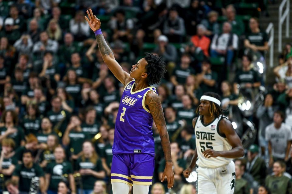 James Madison’s Raekwon Horton, left, celebrates after making a 3-pointer against Michigan State during overtime on Monday, Nov. 6, 2023, in East Lansing.
