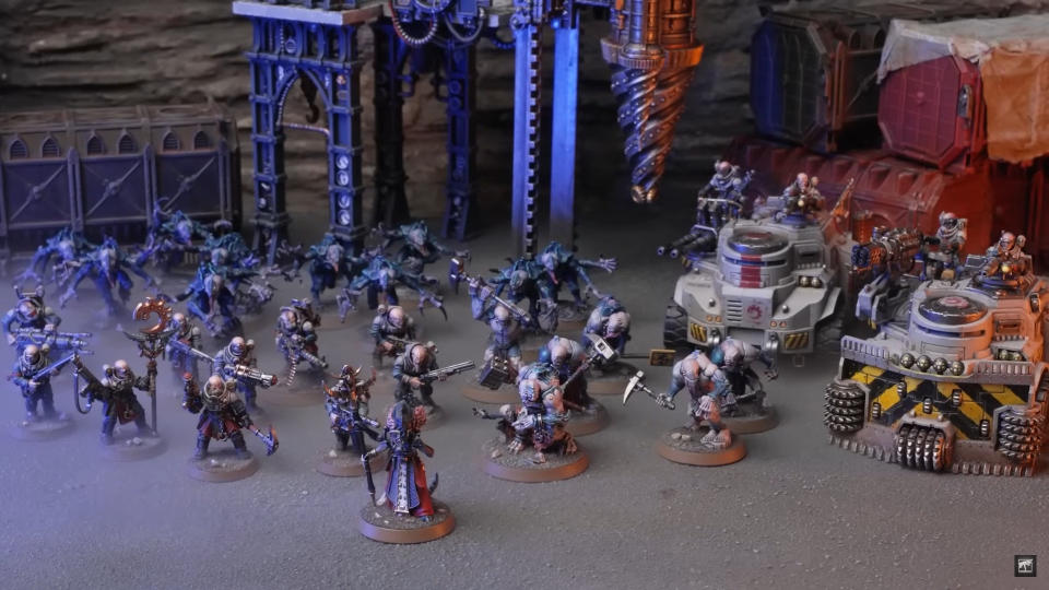 An army of Genestealer Cult models from Warhammer 40K arrayed on a gloomy, industrial board