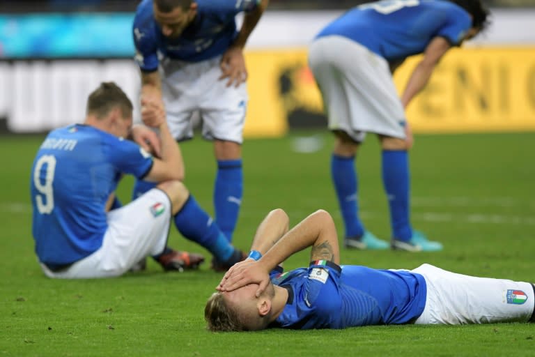 Italian footballers react at the end of their FIFA 2018 World Cup qualification second leg match against Sweden, at the San Siro stadium in Milan, on November 13, 2017