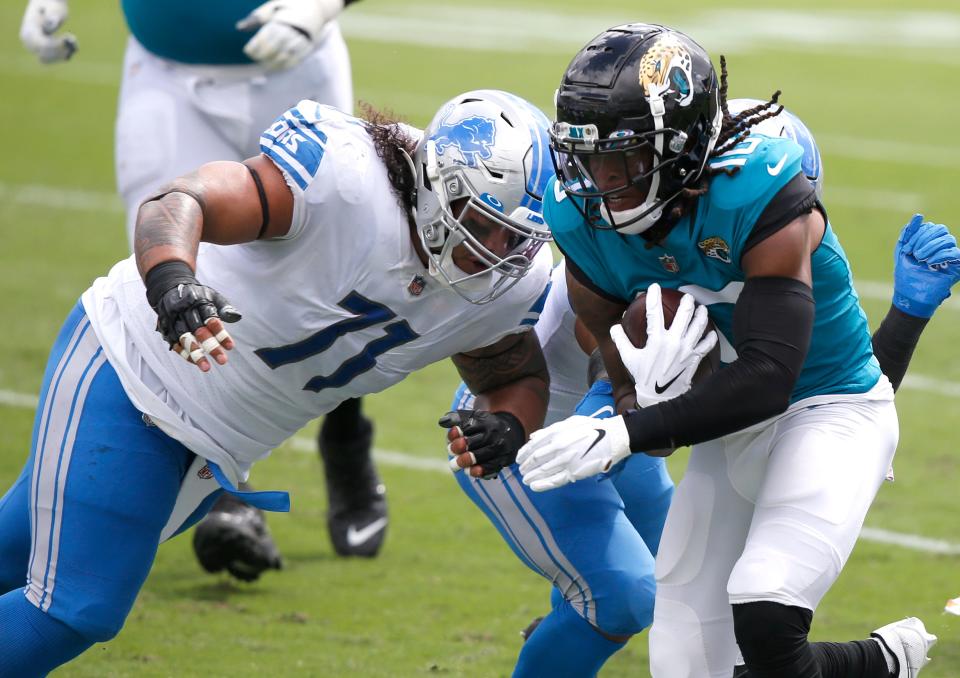 Detroit Lions defensive tackle Danny Shelton tackles Jacksonville Jaguars receiver Laviska Shenault Jr. during the first quarter at TIAA Bank Field, Oct. 18, 2020.