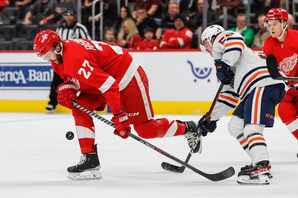 Detroit Red Wings center Michael Rasmussen (27) steals the puck from Edmonton Oilers right wing Kailer Yamamoto (56) during the second period at the Little Caesars Arena in Detroit on Tuesday, Nov. 9, 2021.