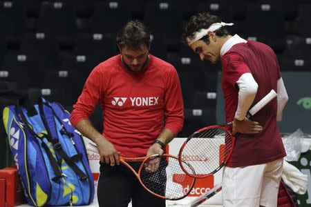 Roger Federer (R) and Stanislas Wawrinka of Switzerland attend a Davis Cup tennis training session at the Pierre Mauroy stadium in Villeneuve d'Ascq, northern France, November 20, 2014. REUTERS/Pascal Rossignol