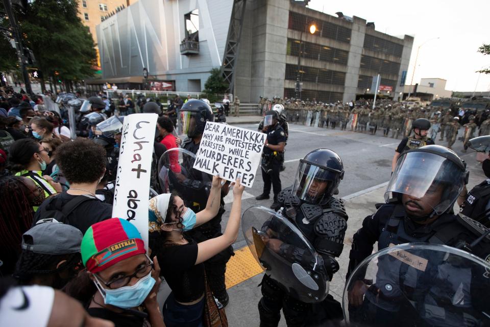 A protester confronts Atlanta police during a demonstration Monday, June 1, 2020, in Atlanta over the death of George Floyd, who died May 25 after being restrained by Minneapolis police.