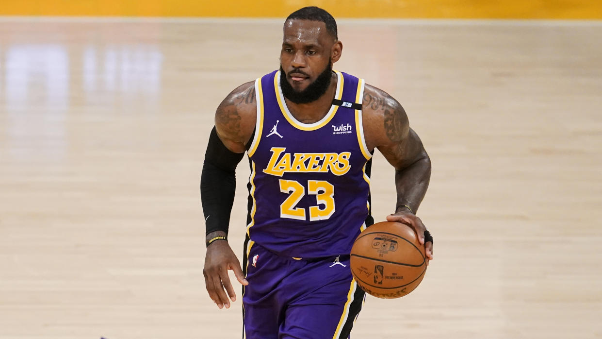 Los Angeles Lakers forward LeBron James dribbles during the first half of an NBA basketball game against the Sacramento Kings Friday, April 30, 2021, in Los Angeles. (AP Photo/Marcio Jose Sanchez)