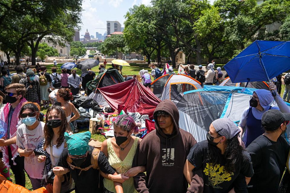 Protesters stand with linked arms April 29 at a short-lived encampment on the University of Texas South Mall. UT has said most of those arrested in last month's pro-Palestinian demonstrations had “no affiliation” with the university and suggested that 