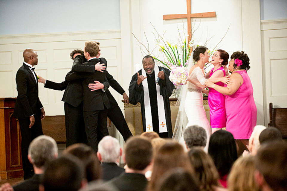 everyone at the church cheering after the wedding